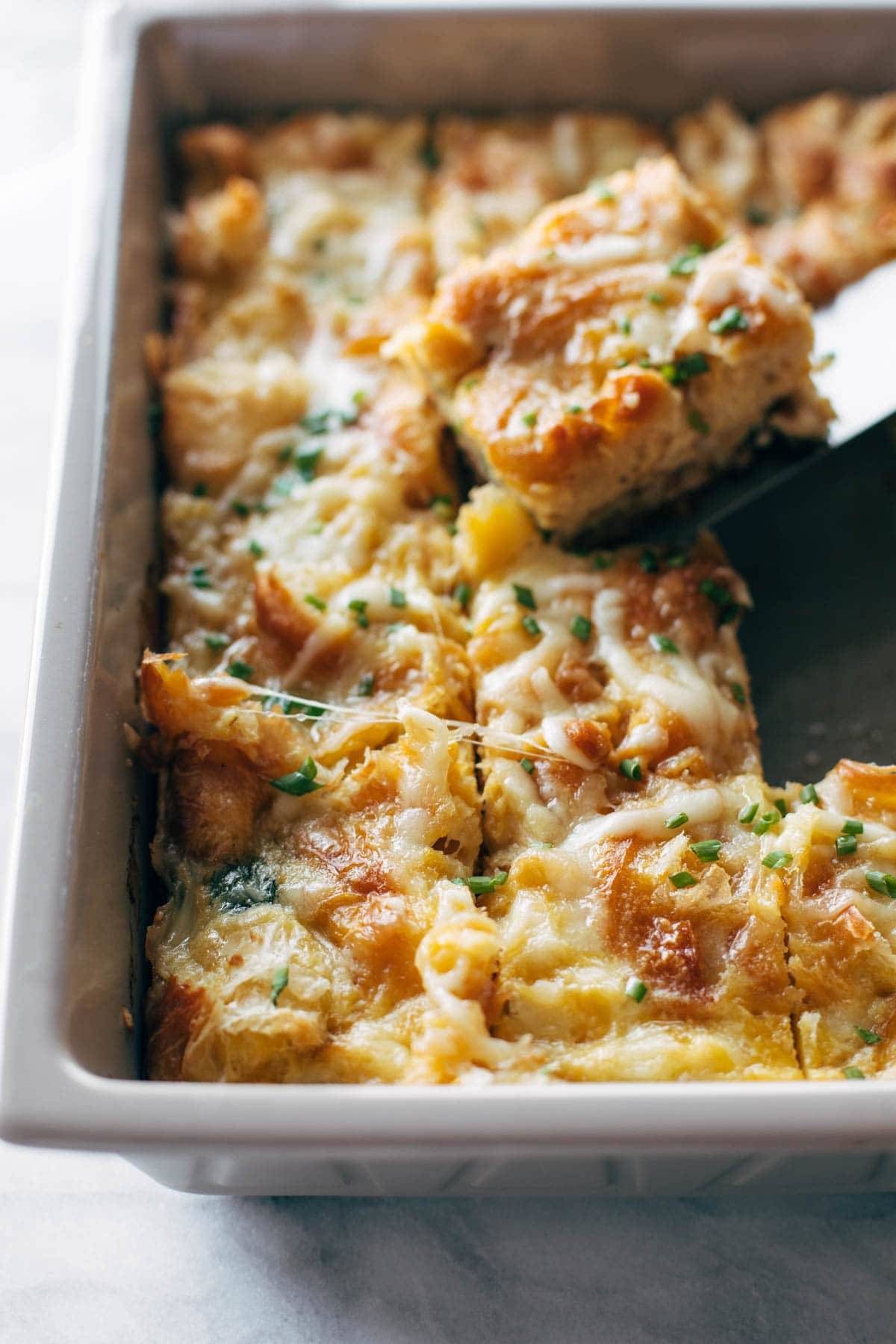 Taking a slice of croissant egg bake.