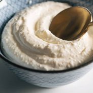 Whipped feta in a bowl with a spoon.